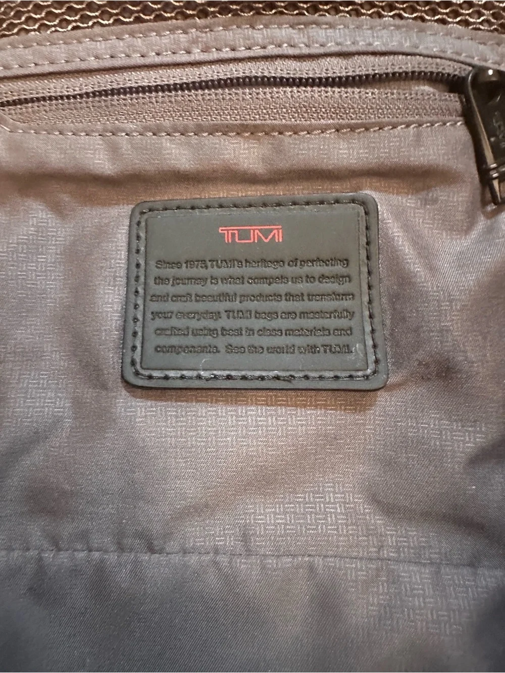Tumi  hanging travel kit  with hook for hanging.